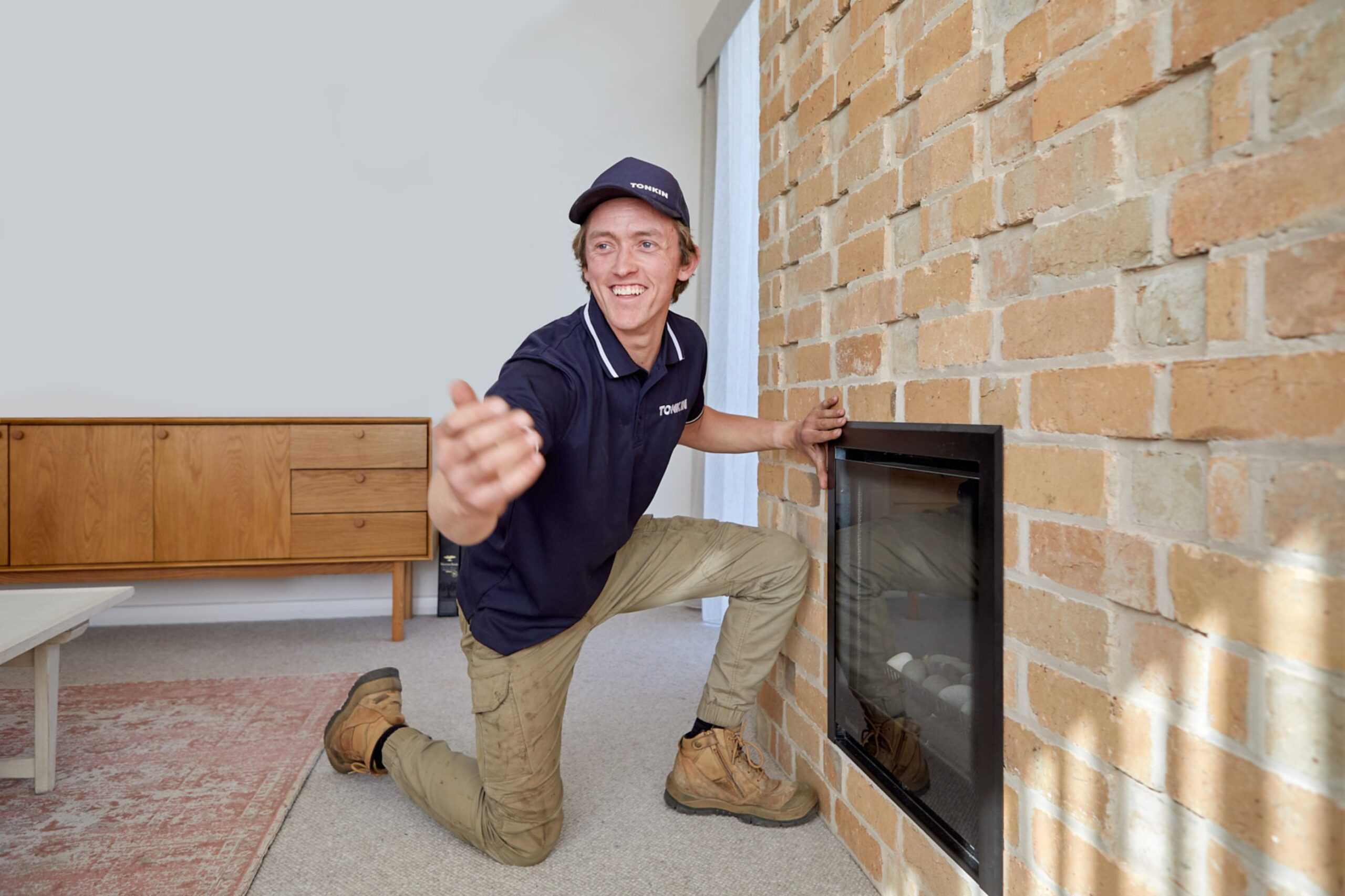 A Tonkin Group employee servicing a gas heating appliance.